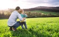 A father with his toddler son outside in spring nature. Copy space. Royalty Free Stock Photo