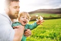 A father with his toddler son outside in spring nature. Royalty Free Stock Photo