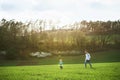 A father with his toddler son on a walk outside in spring nature. Royalty Free Stock Photo