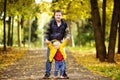 Father and his toddler son walking in autumn forest Royalty Free Stock Photo