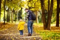 Father and his toddler son walking in autumn forest Royalty Free Stock Photo