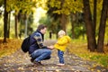 Father and his toddler son walking in autumn park Royalty Free Stock Photo