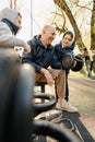 Father with his two sons on an outdoor sports ground in the park Royalty Free Stock Photo