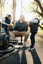 Father with his two sons on an outdoor sports ground in the park Royalty Free Stock Photo