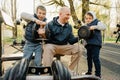 Father with his two sons on an outdoor sports ground in the park Royalty Free Stock Photo