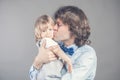 Father with his young baby cuddling and kissing her on cheek. Happy parenthood, love. Bunch of kisses from daddy makes Royalty Free Stock Photo