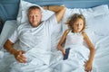 Father and Daughter Sleeping Peacefully Together in a Bright Bedroom During