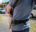 Father hold child in baby sling on the street. Back view