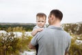 Father holding a baby boy in his hands. Portrait dad with child together. Daddy, little son outdoors. Young father with baby boy Royalty Free Stock Photo