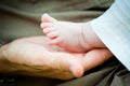 Father holding a baby girl foot