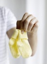 Father holding baby socks. Conceptual image