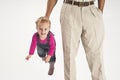 Father holding baby suspended by suspenders