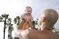 Father holding baby up high in sky Royalty Free Stock Photo