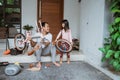 Father holding bicycle frame and daughter carrying wheels Royalty Free Stock Photo