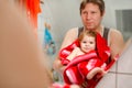 Father holding cute little toddler girl wrapped in towel after taking bath. Happy healthy baby child with wet hairs Royalty Free Stock Photo