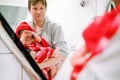 Father holding cute little toddler girl wrapped in towel after taking bath. Happy healthy baby child with wet hairs Royalty Free Stock Photo