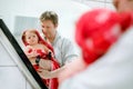 Father holding cute little toddler girl wrapped in towel after taking bath. Happy healthy baby child with wet hairs Royalty Free Stock Photo