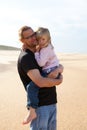 Father holding daughter in arms at the beach Royalty Free Stock Photo