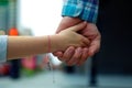 Father holding the daughter/ child hand behind the traffic lights. Royalty Free Stock Photo