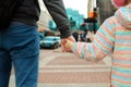 Father holding the daughter/ child hand behind the traffic lights. Royalty Free Stock Photo