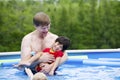 Father holding disabled son in pool Royalty Free Stock Photo