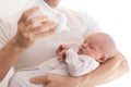 Father holding and feeding his newborn son with milk bottle at home. Royalty Free Stock Photo