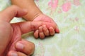 Father holding the hand of his new born son Royalty Free Stock Photo