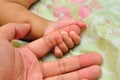 Father holding the hand of his new born son Royalty Free Stock Photo