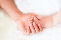 Father holding the hand of his new born son Royalty Free Stock Photo