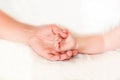 Father holding the hand of his new born son Royalty Free Stock Photo