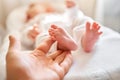 Father holding in the hands feet of newborn baby. Baby little feet in parents hand. Feet skin care closeup. Happy family Royalty Free Stock Photo