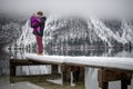 Father holding his baby daughter standing on a snowy pier Royalty Free Stock Photo