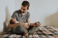 Father holding his baby while using his phone Royalty Free Stock Photo