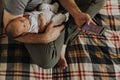 Father holding his baby while using his phone Royalty Free Stock Photo