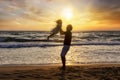 Father holding his daughter in the air on the beach