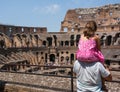 Father is holding his daughter on his shoulders to see the inside arena of Coliseum Royalty Free Stock Photo