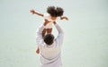 Father holding his daughter up high against sky. african american dady hug girl with sea background Royalty Free Stock Photo