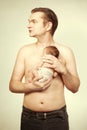 Father posing with his baby boy on chest for portrait Royalty Free Stock Photo