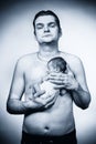 Father posing with his baby boy on chest for portrait Royalty Free Stock Photo