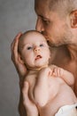 Father holding his newborn baby in hands. Father kissing his baby Royalty Free Stock Photo