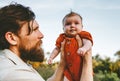 Father holding infant baby outdoor family lifestyle