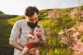 Father holding infant baby walking outdoors family lifestyle