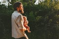 Father holding infant baby walking together in forest Royalty Free Stock Photo