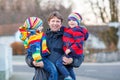 Father holding kid boys, sons on arm outdoors Royalty Free Stock Photo