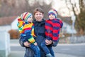 Father holding kid boys, sons on arm outdoors Royalty Free Stock Photo