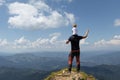 Father holding little girl on his shoulder while on top of the mountain. Sunny summer day Royalty Free Stock Photo