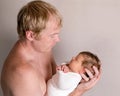 Father holding and looking on little sleeping baby Royalty Free Stock Photo