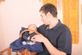 Father holding newborn baby boy lying in wicker basket Royalty Free Stock Photo