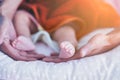 Father holding newborn baby feet. Happy Family concept. Beautiful conceptual image of Maternity, Newborn baby boy feet and hands Royalty Free Stock Photo