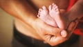 Father holding newborn baby feet on his hands Royalty Free Stock Photo